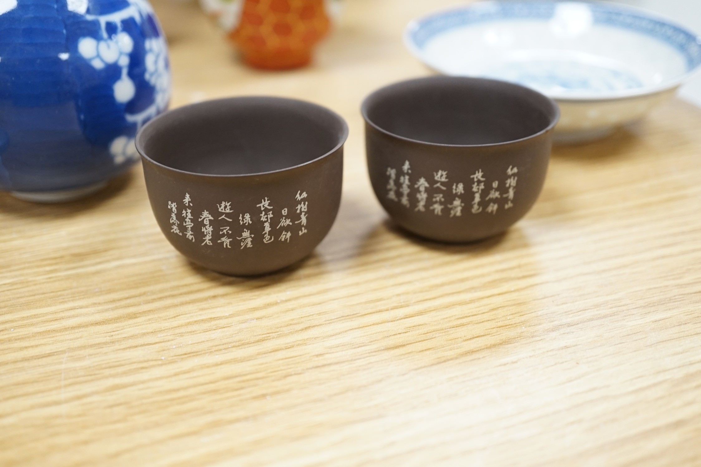 A group of various Chinese ceramics, to include a blue and white prunus jar, an earthenware dish, a famille rose jar and cover and others
